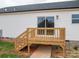 A close up view of the back of the house with a deck and glass sliding doors at 9303 Reepsville Rd, Vale, NC 28168