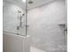 Walk-in shower boasts elegant tiling, dual showerheads, and glass enclosure at 9303 Reepsville Rd, Vale, NC 28168