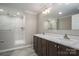 Elegant bathroom featuring a double vanity, marble countertops, and a tiled walk-in shower at 9303 Reepsville Rd, Vale, NC 28168