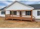 Charming home with a classic covered front porch, wooden decking, and black shutters at 9303 Reepsville Rd, Vale, NC 28168