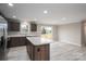 Modern kitchen featuring a center island, modern appliances, dark wood cabinetry, and light wood floors at 9303 Reepsville Rd, Vale, NC 28168