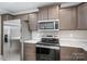 Kitchen featuring modern appliances, a stainless steel refrigerator, and dark wood cabinetry at 9303 Reepsville Rd, Vale, NC 28168