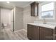 Functional laundry room with window, utility sink, and ample storage at 9303 Reepsville Rd, Vale, NC 28168