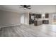 Open-concept living area with seamless flow between the kitchen and living room; featuring modern light wood floors at 9303 Reepsville Rd, Vale, NC 28168