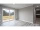 Bright living room features stylish floors and sliding glass doors to a deck, perfect for indoor-outdoor living at 9303 Reepsville Rd, Vale, NC 28168