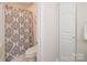 Cozy bathroom with tiled floors and decorative shower curtain at 10933 Hunter Trail Ln, Charlotte, NC 28226