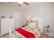 Bedroom with white dresser, ceiling fan, and double closet doors at 10933 Hunter Trail Ln, Charlotte, NC 28226