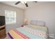 Bedroom with ceiling fan and view of double-hung window at 10933 Hunter Trail Ln, Charlotte, NC 28226