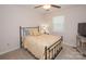 Bedroom with neutral carpet, ceiling fan, and double-hung window at 10933 Hunter Trail Ln, Charlotte, NC 28226