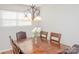 Well-lit dining room with a wood table, chandelier, and blinds at 10933 Hunter Trail Ln, Charlotte, NC 28226