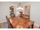 Bright dining room with a wood table, chandelier, and view to other rooms at 10933 Hunter Trail Ln, Charlotte, NC 28226