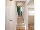 Bright entryway with green door and view of wood flooring and carpeted stairs at 10933 Hunter Trail Ln, Charlotte, NC 28226