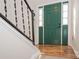 Welcoming entryway with a green door, wood flooring, and decorative handrails at 10933 Hunter Trail Ln, Charlotte, NC 28226