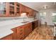 Kitchen with stainless steel appliances, granite counters, wood cabinets, and hardwood floors at 10933 Hunter Trail Ln, Charlotte, NC 28226