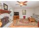 Comfortable living room with a fireplace, ceiling fan, and a neutral color scheme at 10933 Hunter Trail Ln, Charlotte, NC 28226