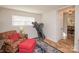 Relaxing living room with an armchair, ottoman, and a treadmill in the corner at 10933 Hunter Trail Ln, Charlotte, NC 28226