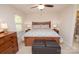 Comfortable bedroom featuring a ceiling fan, windows, and ensuite bathroom at 10933 Hunter Trail Ln, Charlotte, NC 28226