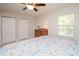 Bright bedroom featuring a ceiling fan, double closets, and cozy decor at 10933 Hunter Trail Ln, Charlotte, NC 28226