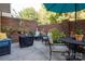 Secluded brick patio with potted plants, comfortable seating, and a shaded dining area at 10933 Hunter Trail Ln, Charlotte, NC 28226