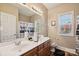 Bathroom featuring double sinks, wood cabinets, and a decorative shower curtain at 4225 Cheshire Glen Dr, Monroe, NC 28110