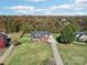 Charming red brick home with manicured lawn, separate garage, and colorful autumn foliage at 4225 Cheshire Glen Dr, Monroe, NC 28110