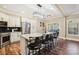 Kitchen island with bar stools, stainless steel appliances and modern lighting at 4225 Cheshire Glen Dr, Monroe, NC 28110