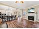 Open concept kitchen and living area with a fireplace and bar seating at 4225 Cheshire Glen Dr, Monroe, NC 28110