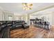 Open-concept living room and kitchen with hardwood floors and modern design at 4225 Cheshire Glen Dr, Monroe, NC 28110