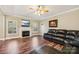Living room featuring a fireplace with TV, ceiling fan, and leather sofa at 4225 Cheshire Glen Dr, Monroe, NC 28110