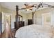 Well-lit main bedroom showcasing wood floors, matching dressers, and an ensuite bathroom at 4225 Cheshire Glen Dr, Monroe, NC 28110