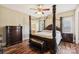 Main bedroom featuring dark wood furniture, a sitting bench, and a ensuite bathroom at 4225 Cheshire Glen Dr, Monroe, NC 28110