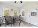 Enclosed patio featuring a ceiling fan, multiple windows, and outdoor dining furniture at 4225 Cheshire Glen Dr, Monroe, NC 28110