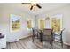 Inviting sunroom with multiple windows, ceiling fan, grey flooring, and comfortable seating for dining at 4225 Cheshire Glen Dr, Monroe, NC 28110