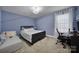 Comfortable bedroom with soft blue walls, plush carpet, cozy daybed, and functional desk area, perfect for rest and productivity at 535 Red Wolf Ln, Clover, SC 29710