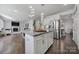 Well-lit kitchen with a granite island and stainless steel appliances leads to a cozy living room at 535 Red Wolf Ln, Clover, SC 29710