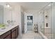 This is an en-suite bathroom featuring a double vanity, a large mirror, and a glass-door shower at 535 Red Wolf Ln, Lake Wylie, SC 29710