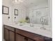 This bathroom features a large mirror, double sinks and a view of the shower at 535 Red Wolf Ln, Lake Wylie, SC 29710