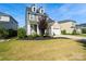 Charming two-story home with a manicured lawn and a two-car garage on a sunny day at 535 Red Wolf Ln, Lake Wylie, SC 29710