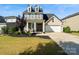 Charming two-story home with a manicured lawn and a two-car garage on a sunny day at 535 Red Wolf Ln, Lake Wylie, SC 29710