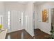 Bright foyer with dark wood flooring and a white front door and accent wall at 535 Red Wolf Ln, Lake Wylie, SC 29710