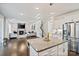 Open concept kitchen and living room features granite countertops, stainless steel appliances, and a cozy fireplace at 535 Red Wolf Ln, Lake Wylie, SC 29710