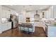 Bright kitchen features granite countertops, an island with seating, stainless steel appliances, and pendant lighting at 535 Red Wolf Ln, Lake Wylie, SC 29710