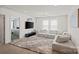 Bright living room features a plush sectional couch, soft rug, and modern decor with big screen television at 535 Red Wolf Ln, Lake Wylie, SC 29710