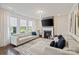 Bright living room features large windows, lots of natural light, a modern fireplace and neutral decor at 535 Red Wolf Ln, Lake Wylie, SC 29710