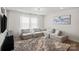 Modern living room offers a cozy gray sectional, stylish decor, and bright natural light for relaxation and comfort at 535 Red Wolf Ln, Lake Wylie, SC 29710