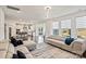 Open concept living room and kitchen features large windows, lots of natural light, and neutral decor at 535 Red Wolf Ln, Lake Wylie, SC 29710