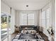 Cozy living room with a modern sofa, neutral decor, lots of natural light, and a decorative glass coffee table at 535 Red Wolf Ln, Lake Wylie, SC 29710