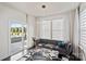 Cozy living room with a modern sofa, neutral decor, lots of natural light, and a decorative glass coffee table at 535 Red Wolf Ln, Lake Wylie, SC 29710