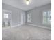 Spacious bedroom with carpeting, window shutters, and ensuite bathroom access at 1017 N Sharon Amity Rd, Charlotte, NC 28211