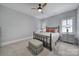 Bedroom with metal bed frame, gray carpet, and window shutters at 1017 N Sharon Amity Rd, Charlotte, NC 28211